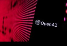 A Quiet Move With Huge Stakes Close-up of a smartphone displaying the OpenAI logo against a vibrant digital background