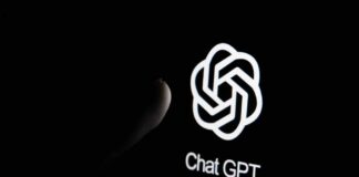 Close-up of a hand reaching towards the ChatGPT logo on a smartphone screen