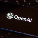 Close-up of a smartphone displaying the OpenAI logo on a dark screen