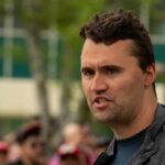 Man speaking outdoors at a public gathering