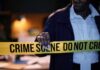 Police officer holding crime scene tape