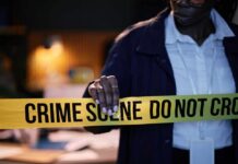 Police officer holding crime scene tape