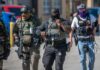 Agents Everywhere? Homan Drops Bombshell Group of police officers in tactical gear walking in an urban area