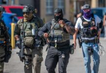 Agents Everywhere? Homan Drops Bombshell Group of police officers in tactical gear walking in an urban area