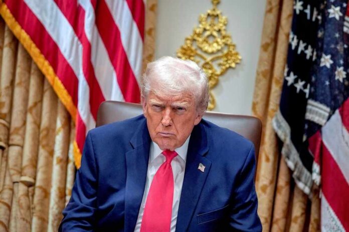 President,Donald,Trump,Speaks,During,Cabinet,Meeting,In,The,Cabinet Donald Trump seated in the Oval Office with a serious expression