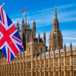 British flag waving in front of the Parliament building in London