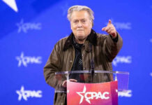 Bannon’s War Room Surges — Why Now? Person speaking at CPAC conference blue background