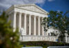 Federal Judge Blocked Without Impeachment Process Large neoclassical building with columns behind trees
