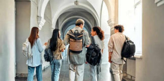 Five students walking in a school hallway together