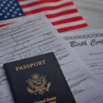 Denaturalization Dragnet Expands—Who’s Next? Passport and documents on table with American flag