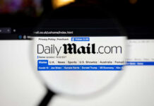 Daily Mail website under magnifying glass showing headlines