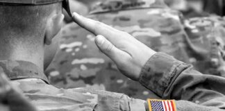 Soldier saluting with an American flag patch on sleeve