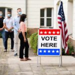 California’s Election System Faces Fresh Scrutiny Voters wearing masks line up outside a polling place