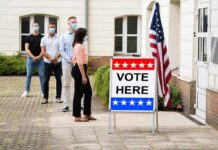 California’s Election System Faces Fresh Scrutiny Voters wearing masks line up outside a polling place