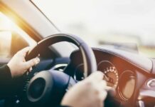 Are Touchscreens Making America’s Roads More Dangerous? Hands gripping a steering wheel inside a car