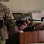 soldier holding a quadcopter drone