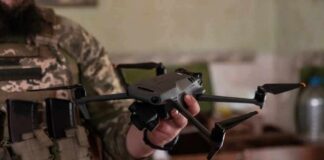 soldier holding a quadcopter drone