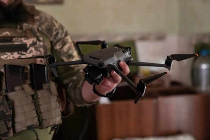 shutterstock_2308712675 soldier holding a quadcopter drone
