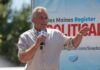 Washington’s Vaccine Debate Isn’t Going Away Man speaking on an outdoor stage with a microphone