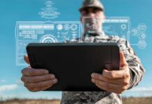 New Marine Network Keeps AI Alive A soldier holding a tablet displaying digital data overlays
