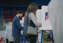 Noncitizen Voting Case Draws National Attention A person casting their vote at a polling station