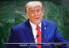 Trump Reignites Election Security Debate Before Midterms A man in a blue suit delivering a speech at a podium