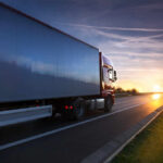 Fatal Turnpike Crash Exposes Licensing Gaps A truck driving on a highway during sunset