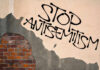 Political Rhetoric Sparks Fresh Antisemitism Concerns Stop antisemitism graffiti on a worn brick wall