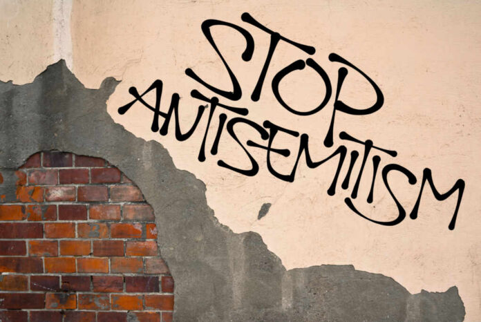 stop-antisemitism-handwritten437195251jpg Stop antisemitism graffiti on a worn brick wall