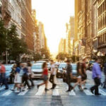 Study Finds America’s Assimilation Story Continues People crossing a busy city street at sunset