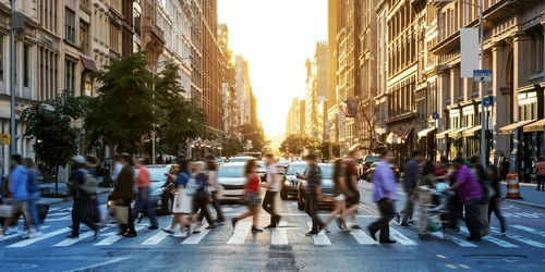 us-people2270903133 People crossing a busy city street at sunset