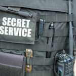 Butler Review Exposes Preventable Security Breakdown Tactical vest with equipment and a visible service patch