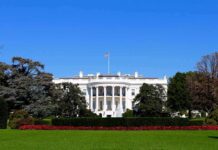Teleprompter Mole Cashes In—Then Pays The White House facade with flag and gardens