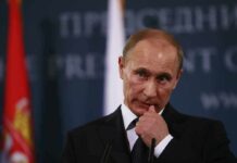 The War Just Crossed Another Dangerous Line man in suit at podium touching his face