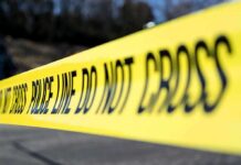 Yellow police tape stretched across an outdoor scene