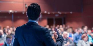 Speaker addressing an audience in a conference hall