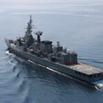 Modern naval warship cruising on calm sea