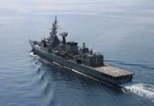 Modern naval warship cruising on calm sea