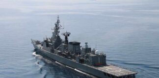 Modern naval warship cruising on calm sea