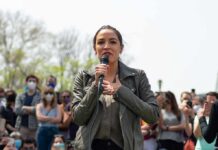 Congressman’s Star Power Gets A Reality Check woman speaking into a microphone at an outdoor rally