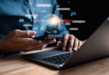Person using smartphone and laptop with AI hologram