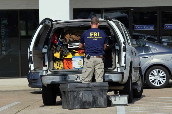 FBI evidence technician working at the open back of an SUV