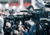 Border Showdown At The Ballot Broadcast cameras on tripods at a press event