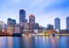 City skyline with illuminated waterfront at dusk