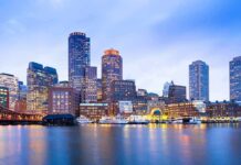 City skyline with illuminated waterfront at dusk