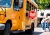 Dad Draws Gun, Sheriff Says No Crime School bus with extended stop sign near students on sidewalk