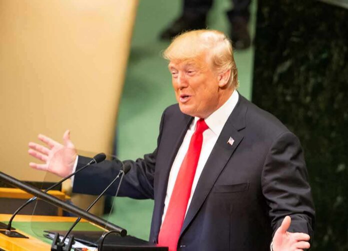 speaker in suit gestures at podium