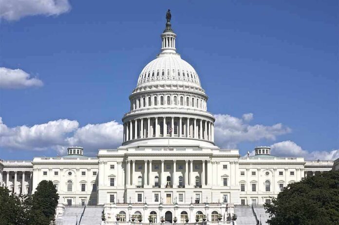 shutterstock_119536138 United States Capitol building with white dome under blue sky