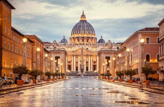 St. Peter's Basilica at the end of a wet street at dusk