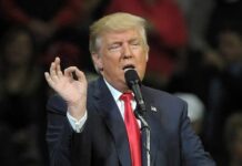 America Just Pumped More Oil Than Ever Donald Trump speaking at a rally with microphone and raised hand gesture
